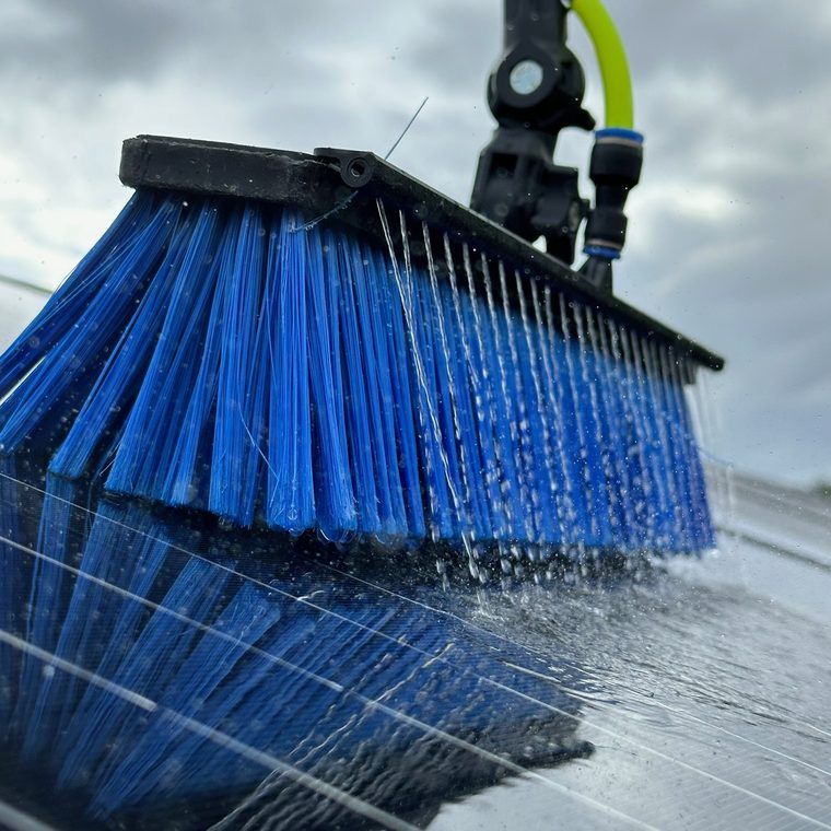 Soft brush washing a residential solar panel