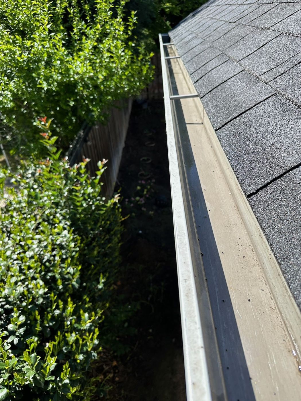 A freshly cleaned rain gutter running along a roofline
