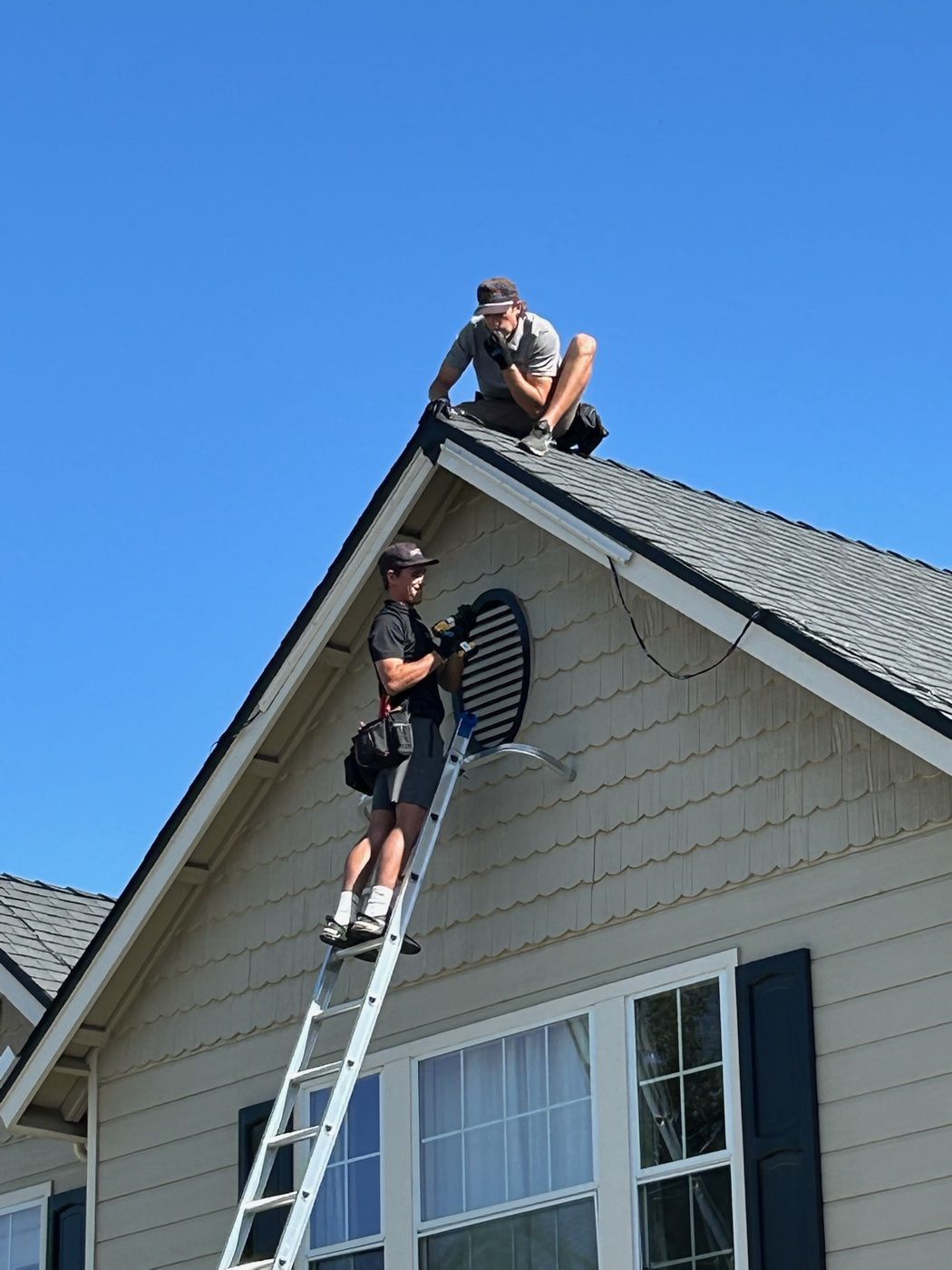 Technician installing holiday roofline lights