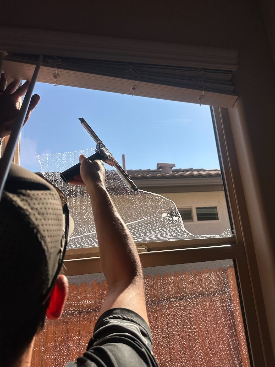 Technician cleaning interior window glass